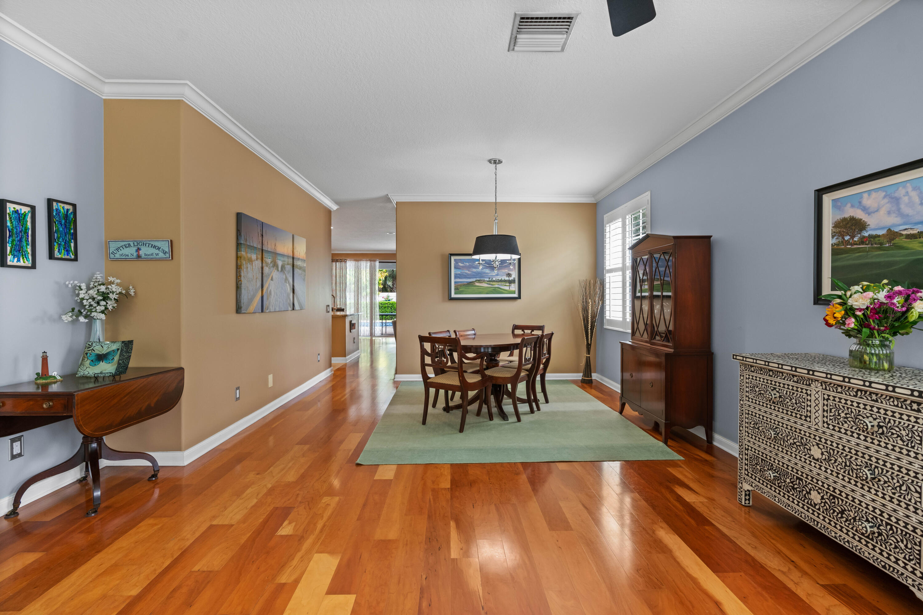 144 Sweet Bay Circle Jupiter, FL 33458 - Photo 4 of 46 a dining room with furniture a chandelier and wooden floor