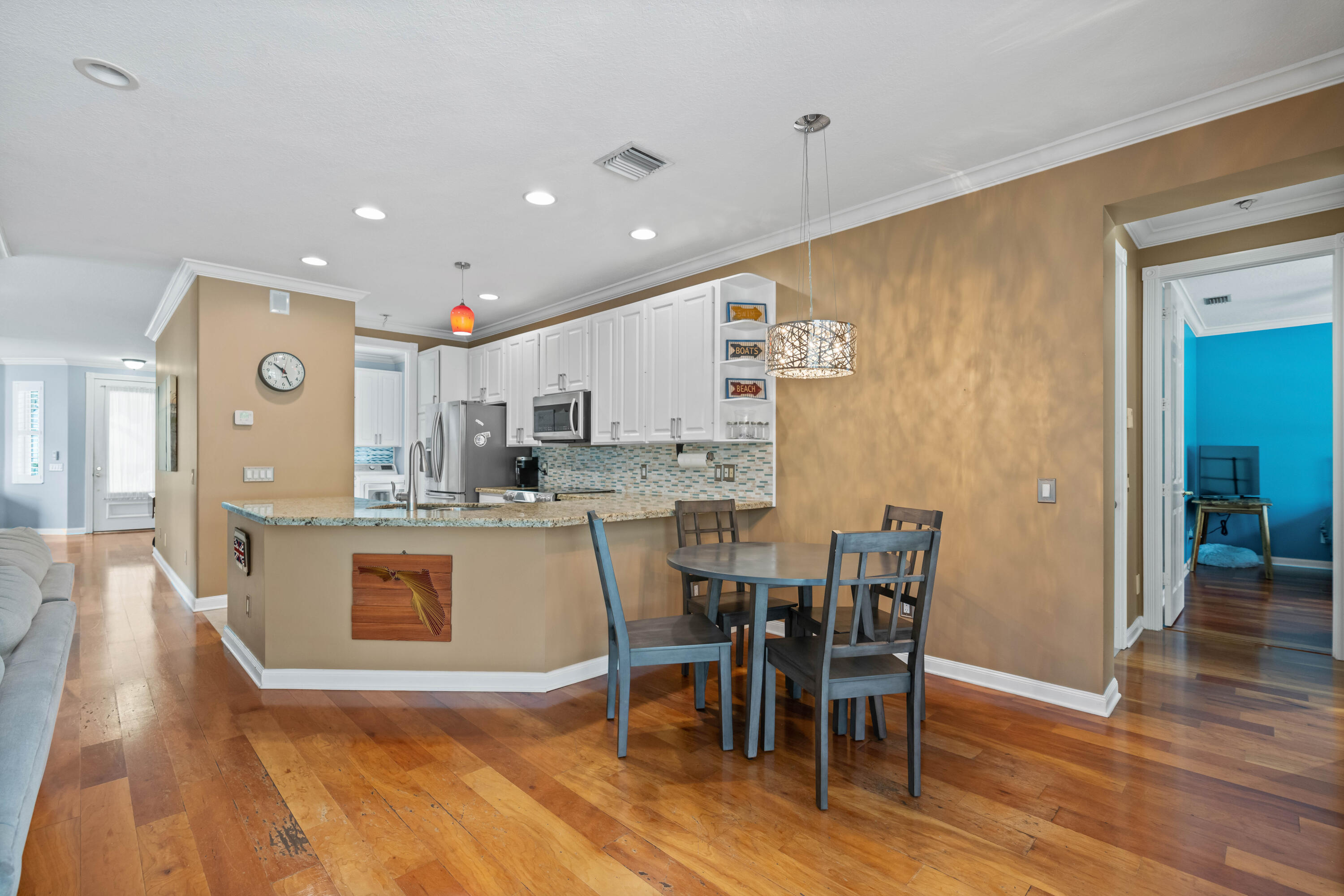 144 Sweet Bay Circle Jupiter, FL 33458 - Photo 8 of 46 a kitchen with stainless steel appliances granite countertop a dining table chairs and granite counter tops