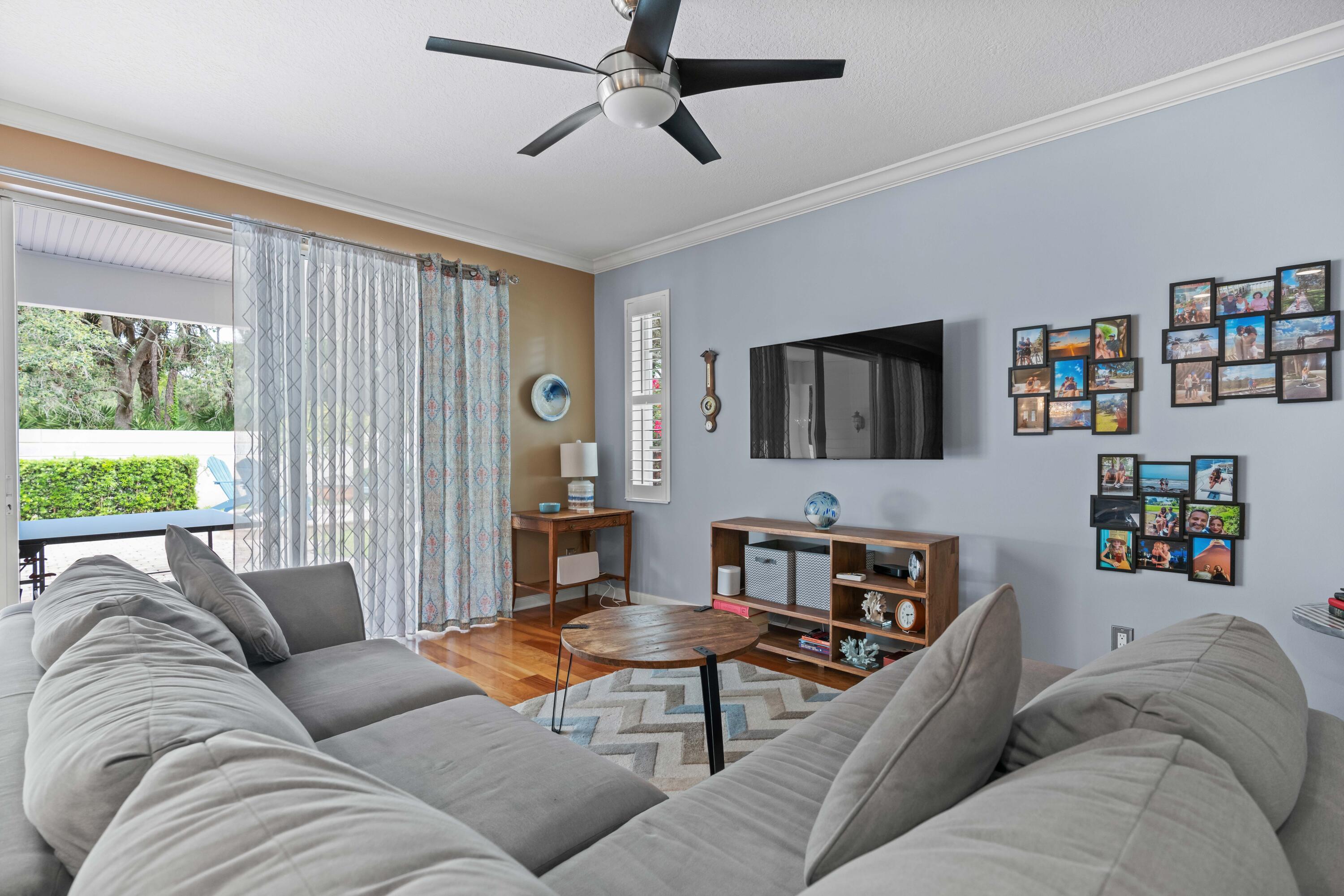 144 Sweet Bay Circle Jupiter, FL 33458 - Photo 9 of 46 a living room with furniture and a flat screen tv