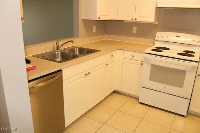 a kitchen with a sink cabinets and appliances