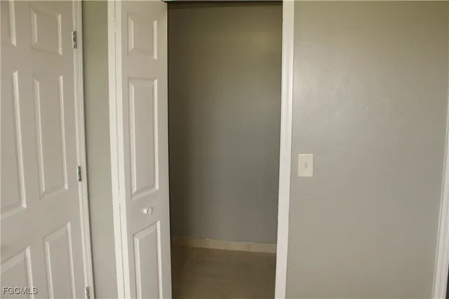 a bathroom with a granite countertop toilet and a sink
