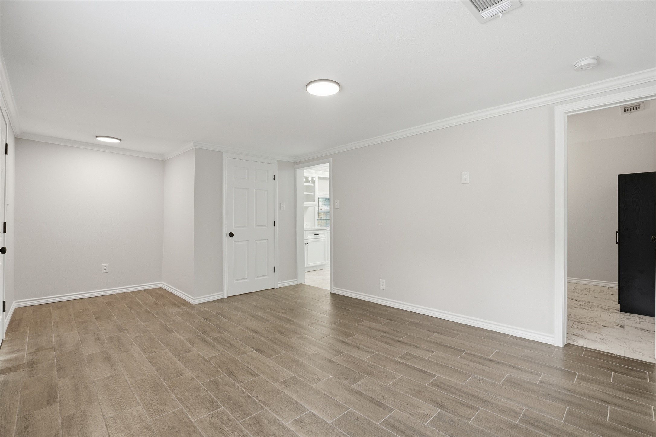 6518 Paris Street Houston, TX 77021 - Photo 7 of 23 a view of an empty room with wooden floor and a window