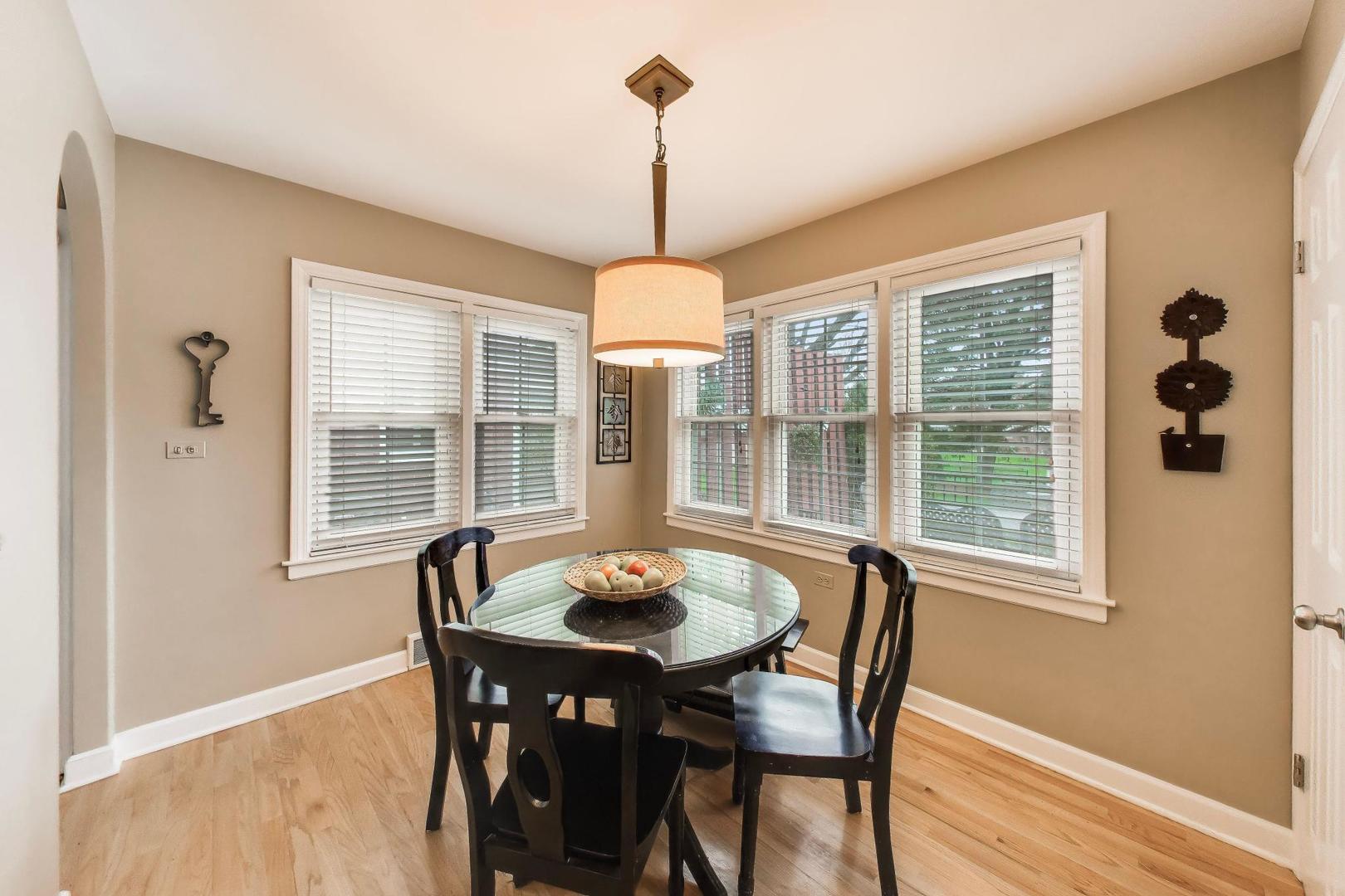 511 South Hi Lusi Avenue Mount Prospect, IL 60056 - Photo 14 of 51 a dining room with furniture a chandelier and wooden floor