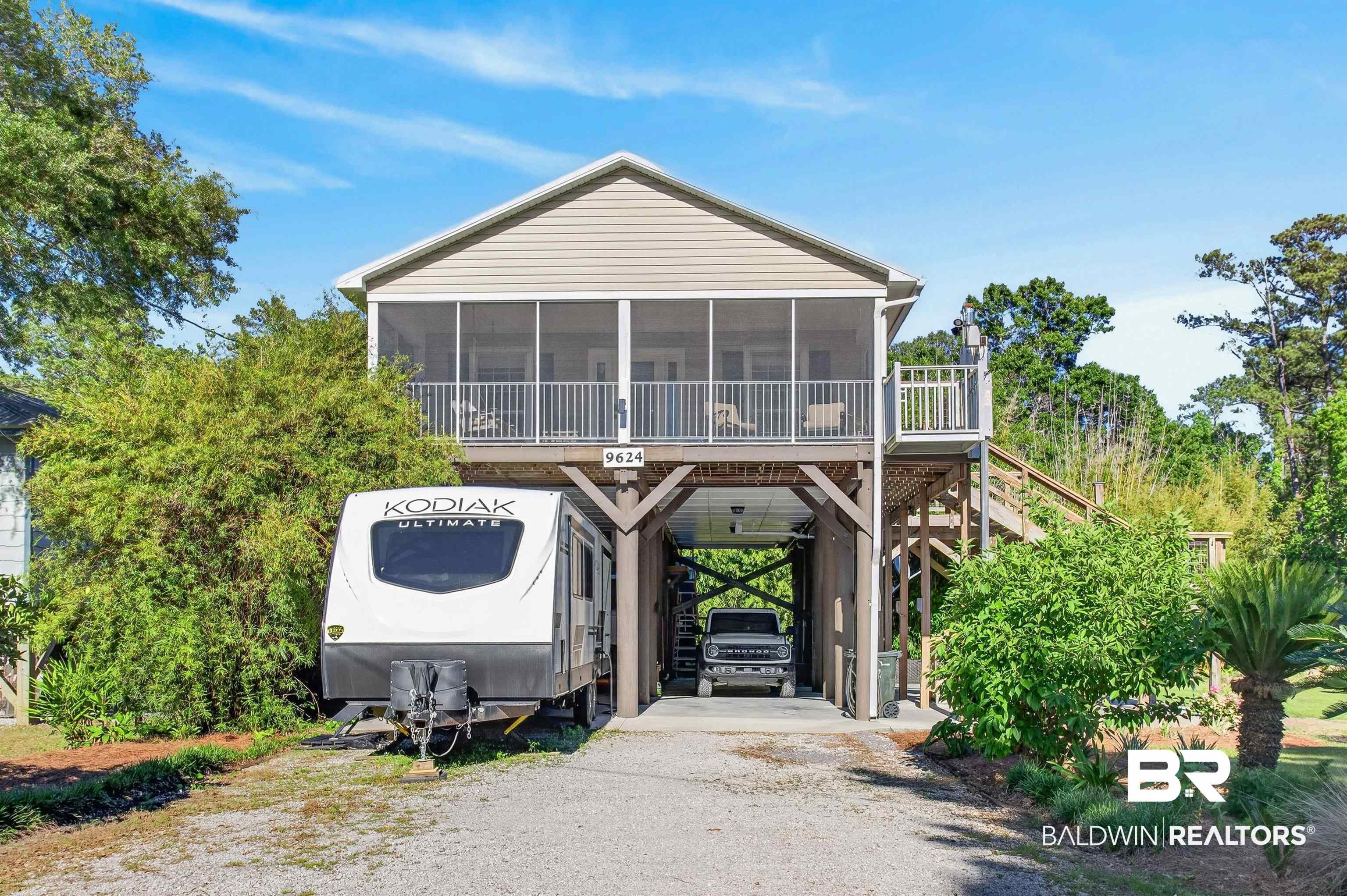 9624 North Bay Street Foley, AL 36535 - Photo 43 of 59 Raised coastal-style home featuring a screened porch and an open deck