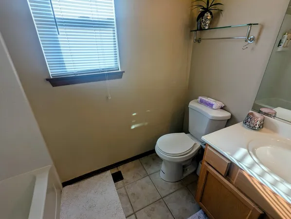 a white toilet sitting next to a bathroom sink