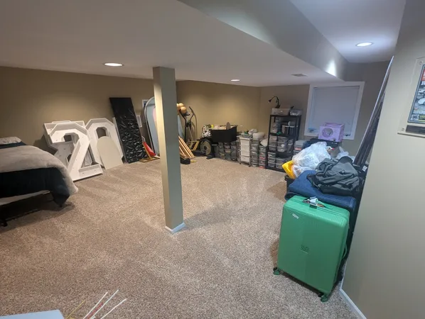 a view of a livingroom with furniture and a large window