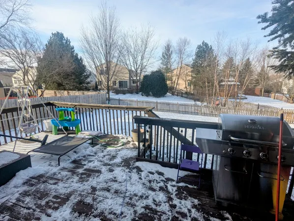 a view of a deck with a yard chairs and wooden fence