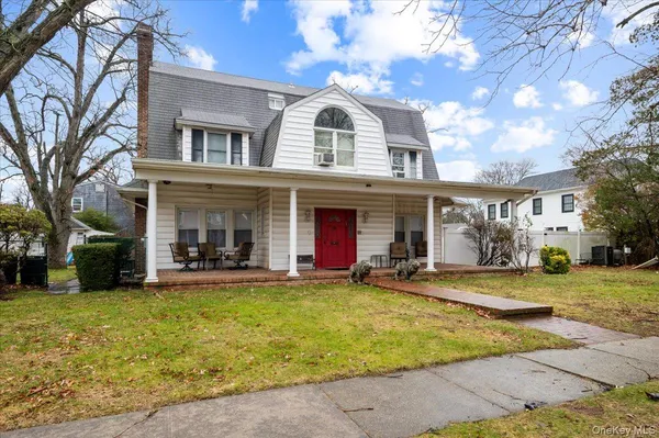 a view of a house with a yard porch and sitting area