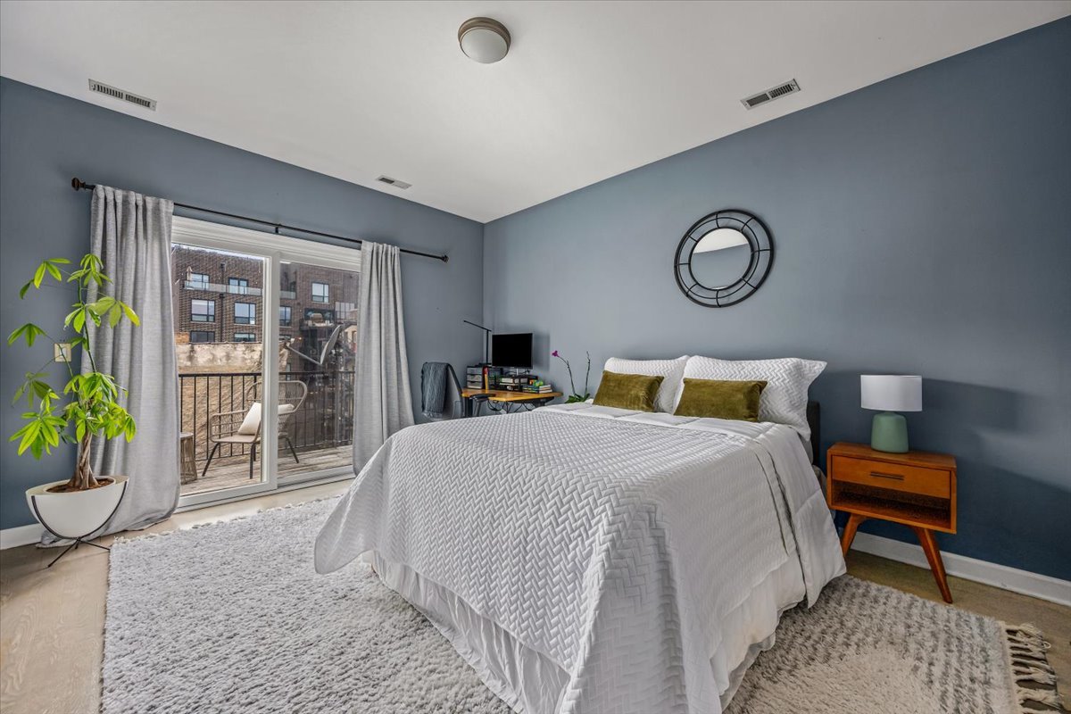 618 North May Street, Unit C Chicago, IL 60642 - Photo 16 of 30 a bedroom with a bed and a table