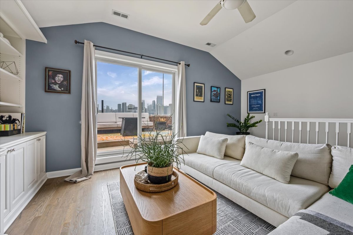 618 North May Street, Unit C Chicago, IL 60642 - Photo 20 of 30 a living room with furniture and a large window