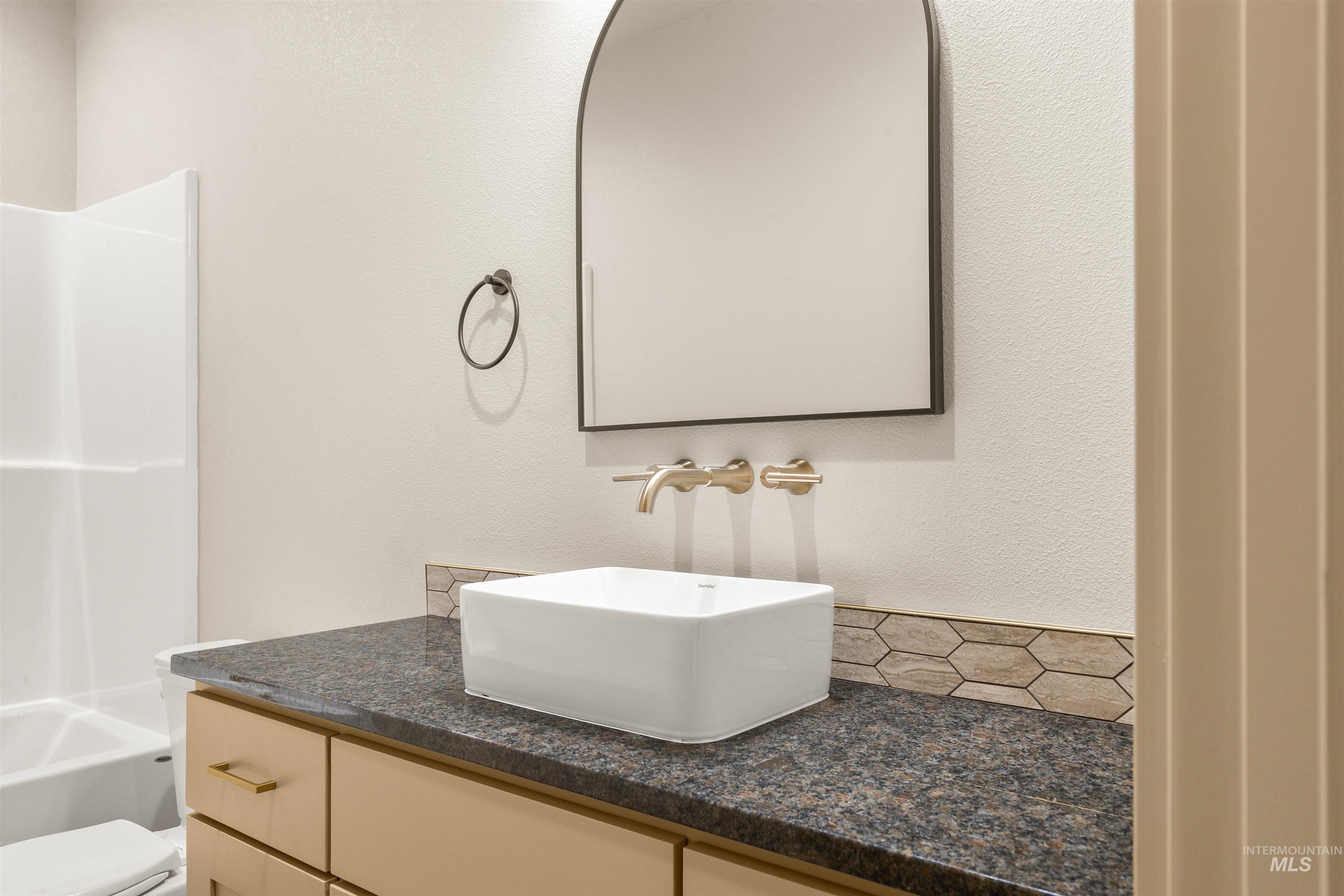 335 Warner Avenue Lewiston, ID 83501 - Photo 38 of 43 Full bathroom featuring vanity, a textured wall, and shower combination