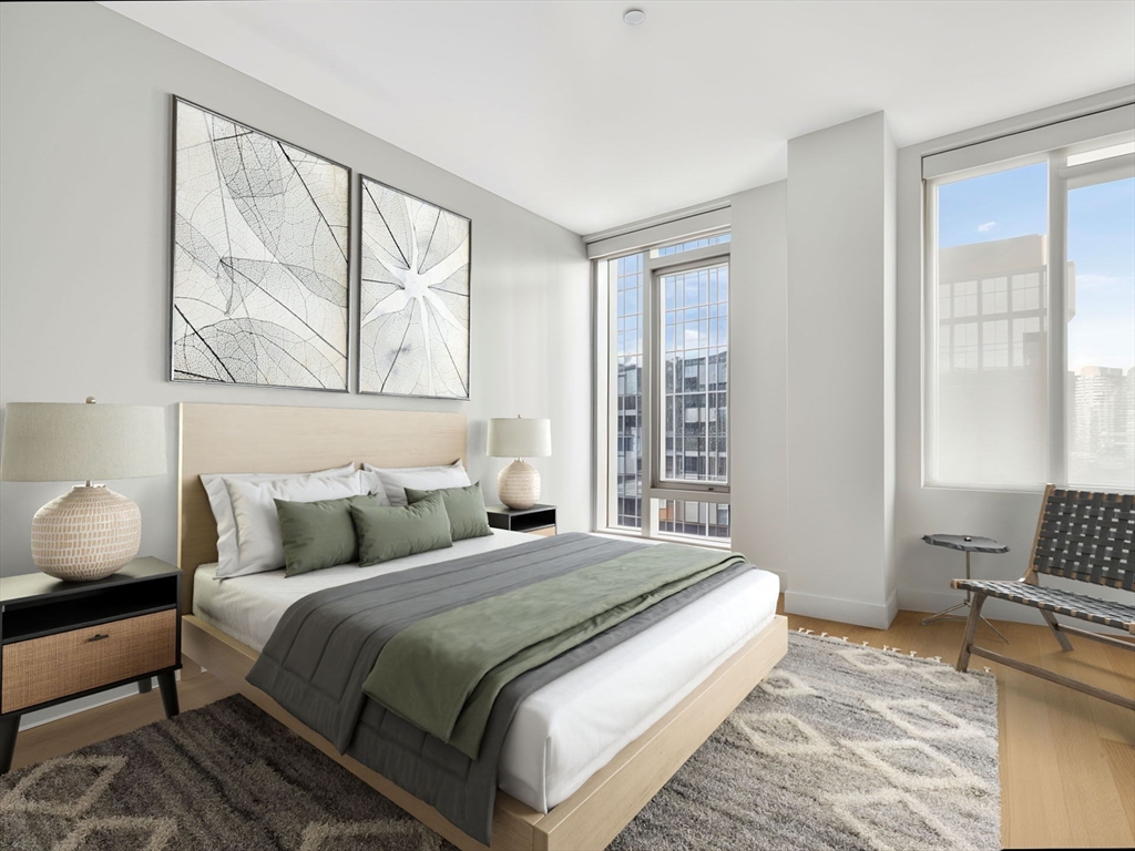 135 Seaport Boulevard, Unit 1907 Boston, MA 02210 - Photo 5 of 13 a bedroom with a bed and wooden floor