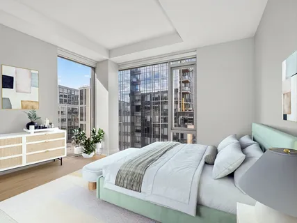 a spacious bedroom with a bed and a large window