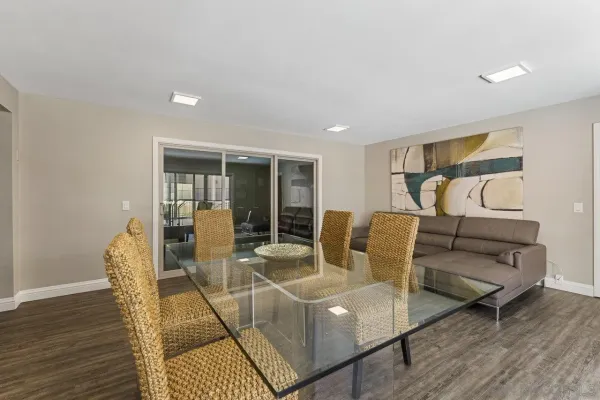 a living room with furniture a wooden floor and next to window