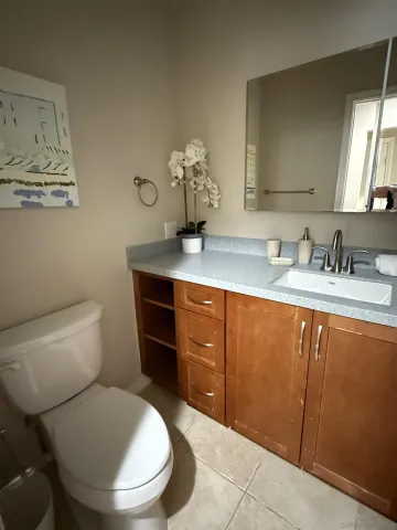 a bathroom with a toilet a sink and mirror