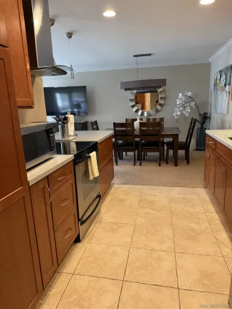 a kitchen with granite countertop a sink a counter top space appliances and cabinets