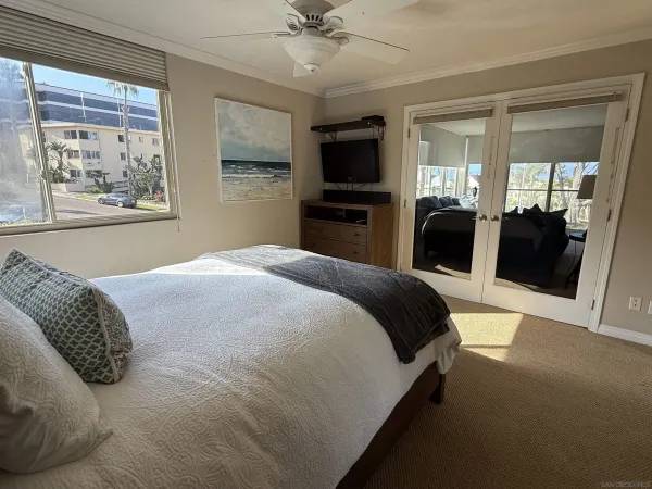 a bedroom with a large bed and a tv