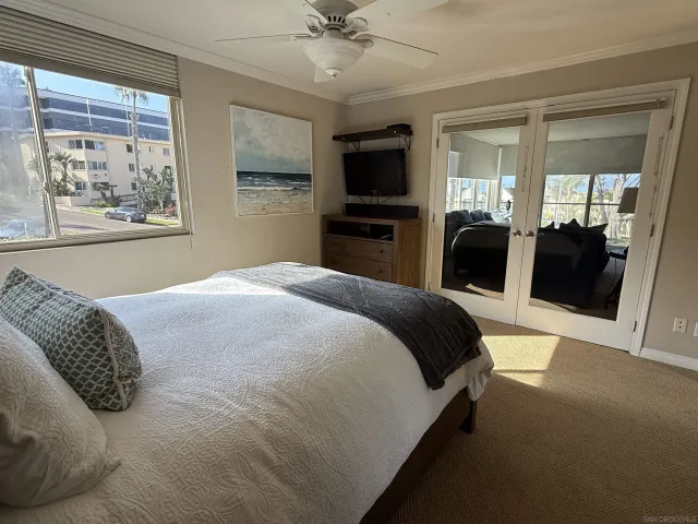 a bedroom with a large bed and a tv