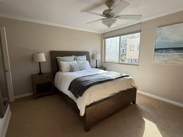 a spacious bedroom with a bed and window
