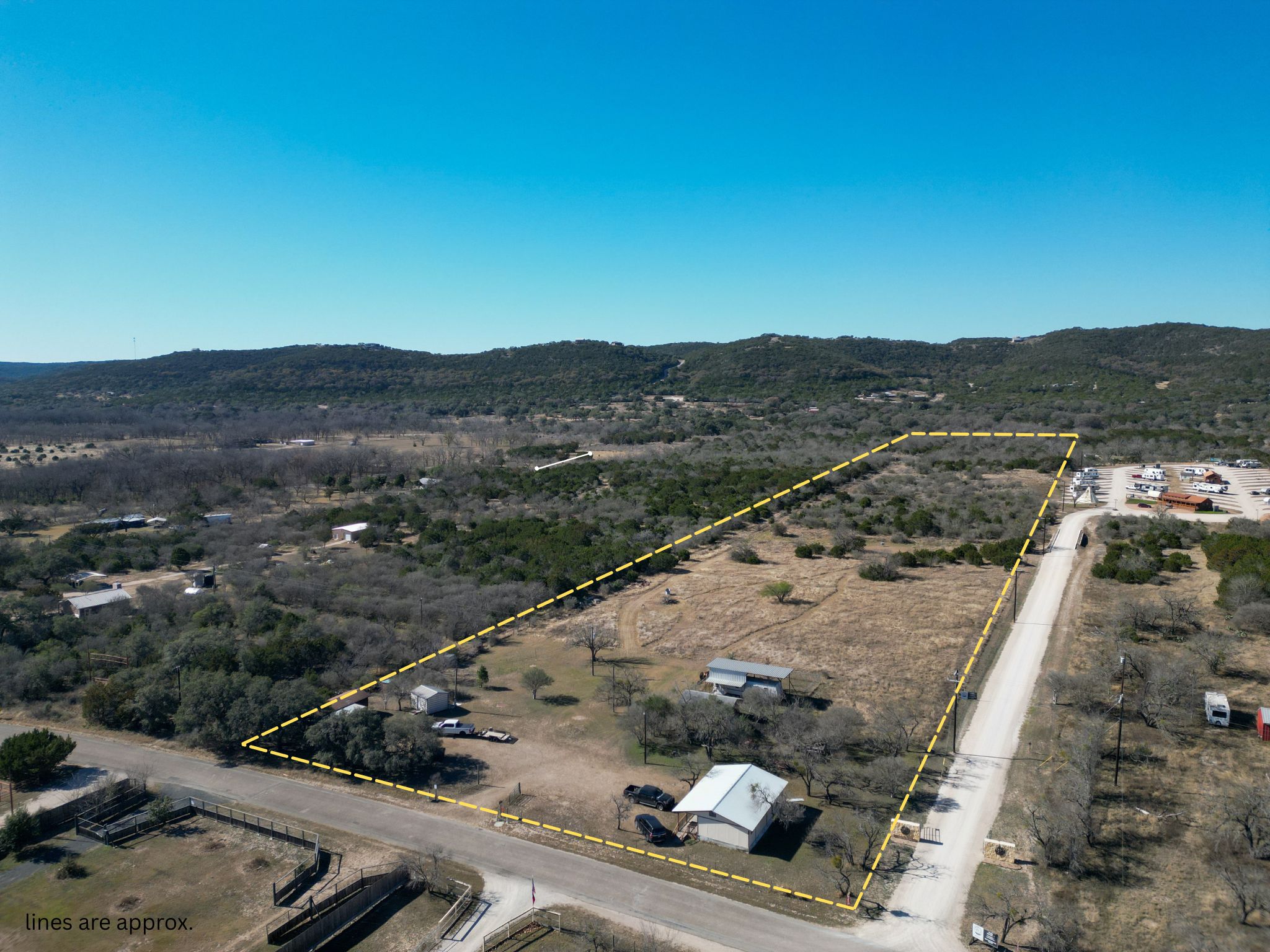 831 Magers Road Concan, TX 78838 - Photo 1 of 39 Aerial view of sparsely populated area with a mountainous background and property parcel outlined