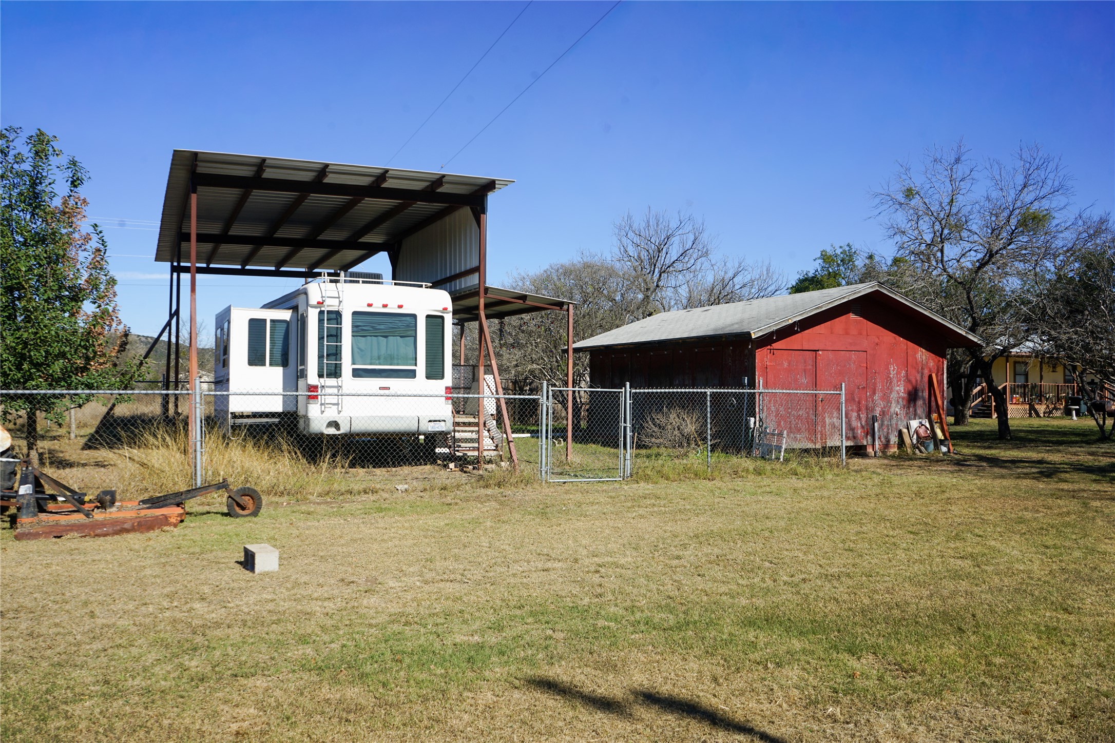 831 Magers Road Concan, TX 78838 - Photo 22 of 39 View of pole building with a gate and a carport