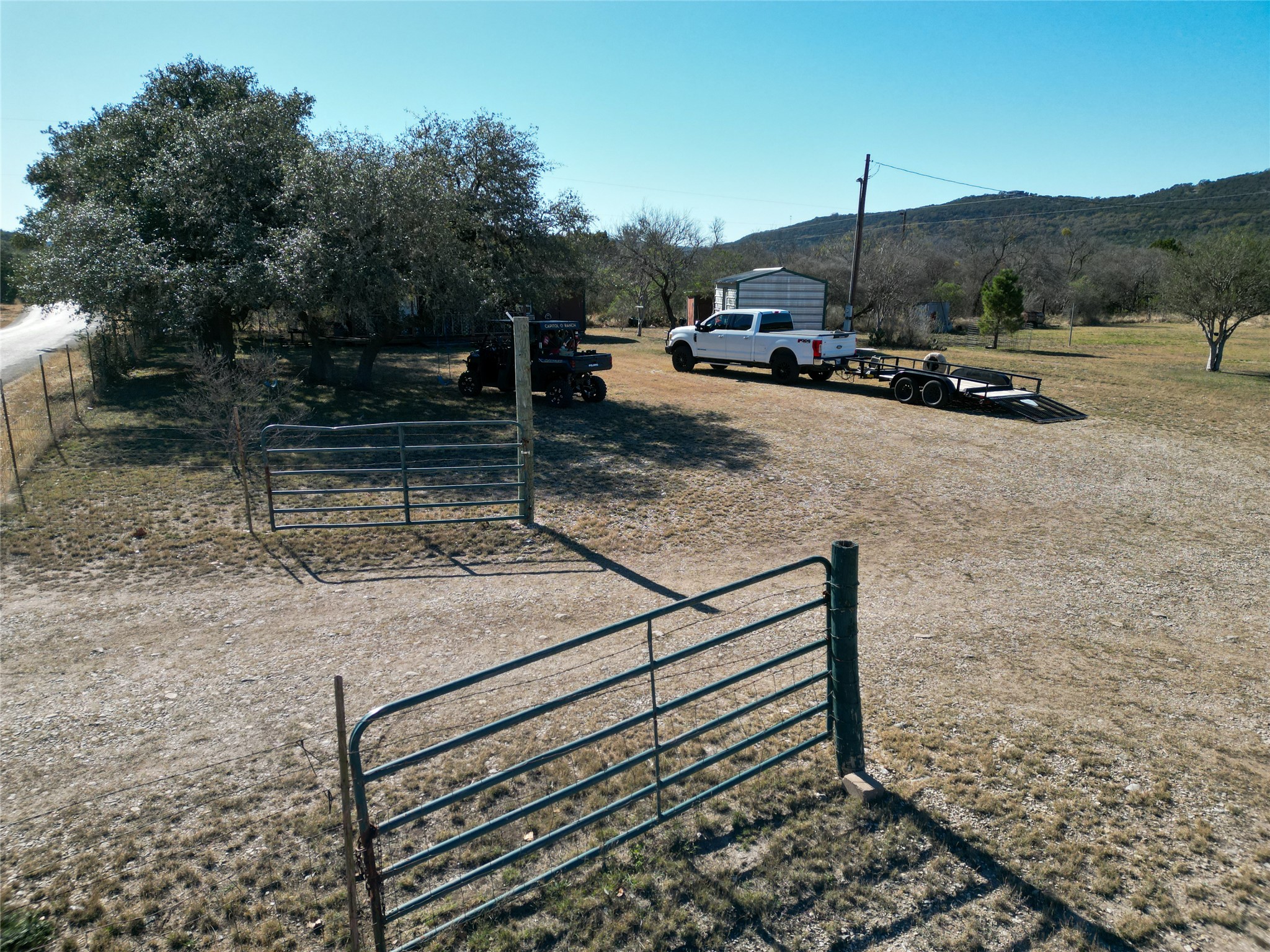 831 Magers Road Concan, TX 78838 - Photo 7 of 39 View of yard with a gate, a rural view, and a mountain view