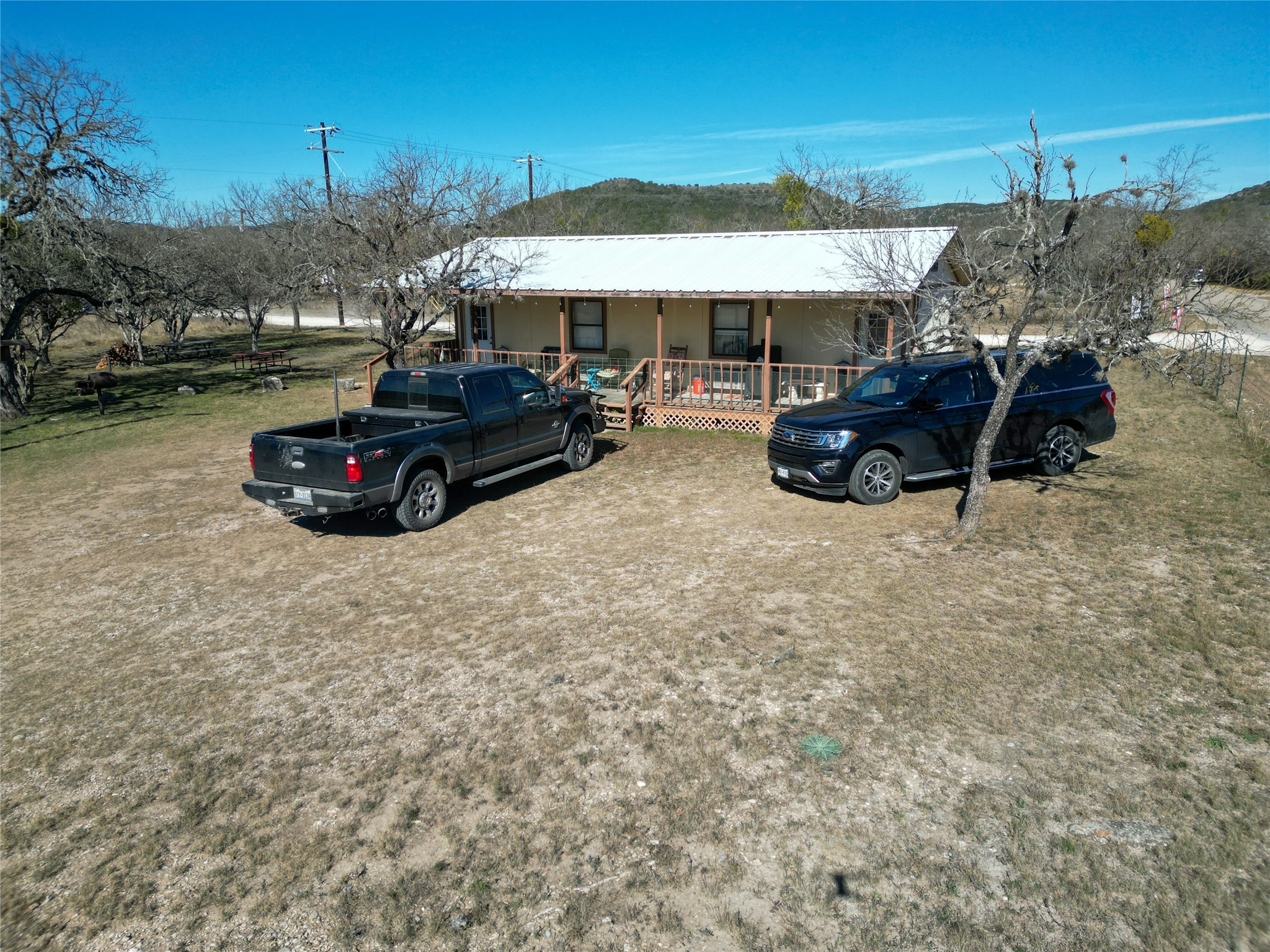 831 Magers Road Concan, TX 78838 - Photo 8 of 39 Ranch-style home with a metal roof and a porch