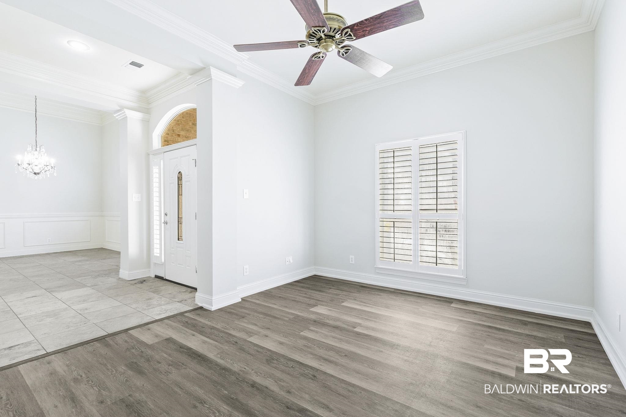 13 Bugle Retreat Daphne, AL 36527 - Photo 15 of 40 Empty room with ceiling fan with notable chandelier, light hardwood / wood-style flooring, and crown molding