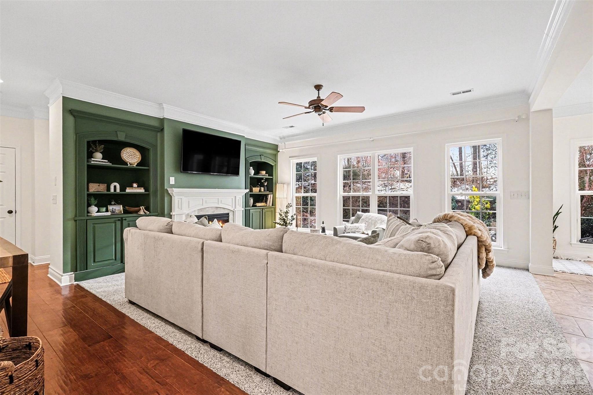 126 Burtons Barn Road Mooresville, NC 28115 - Photo 11 of 48 a living room with furniture a flat screen tv and a fireplace