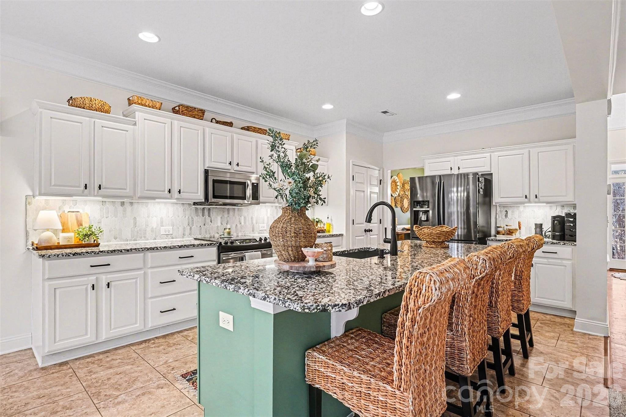126 Burtons Barn Road Mooresville, NC 28115 - Photo 19 of 48 a kitchen with stainless steel appliances granite countertop a stove top oven a sink dishwasher and cabinets