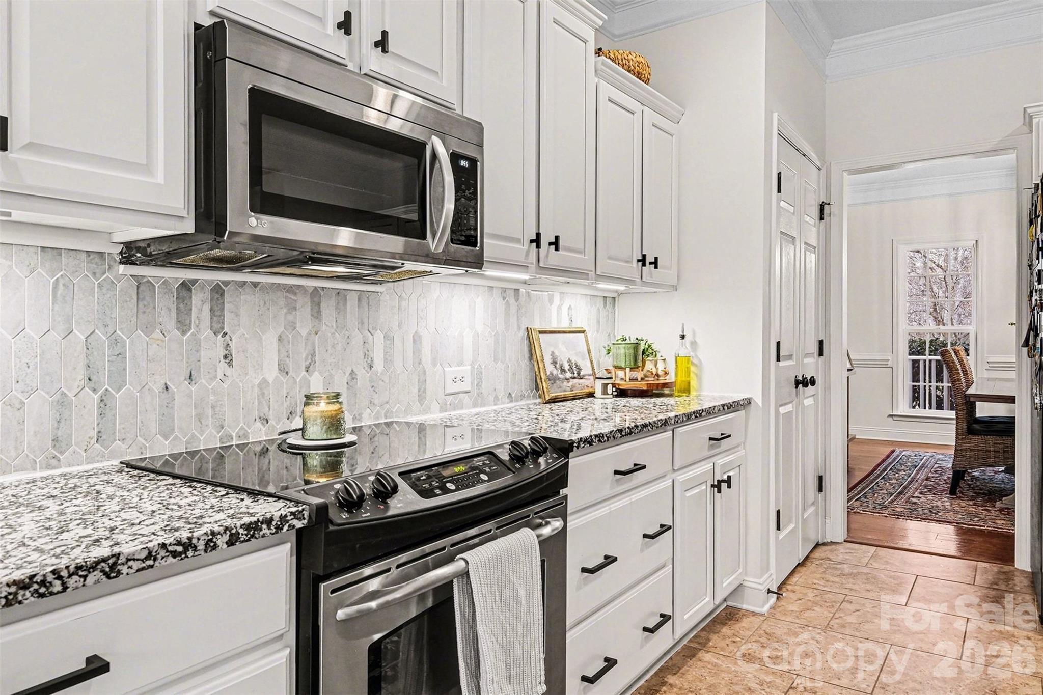 126 Burtons Barn Road Mooresville, NC 28115 - Photo 20 of 48 a kitchen with stainless steel appliances granite countertop a stove and a microwave