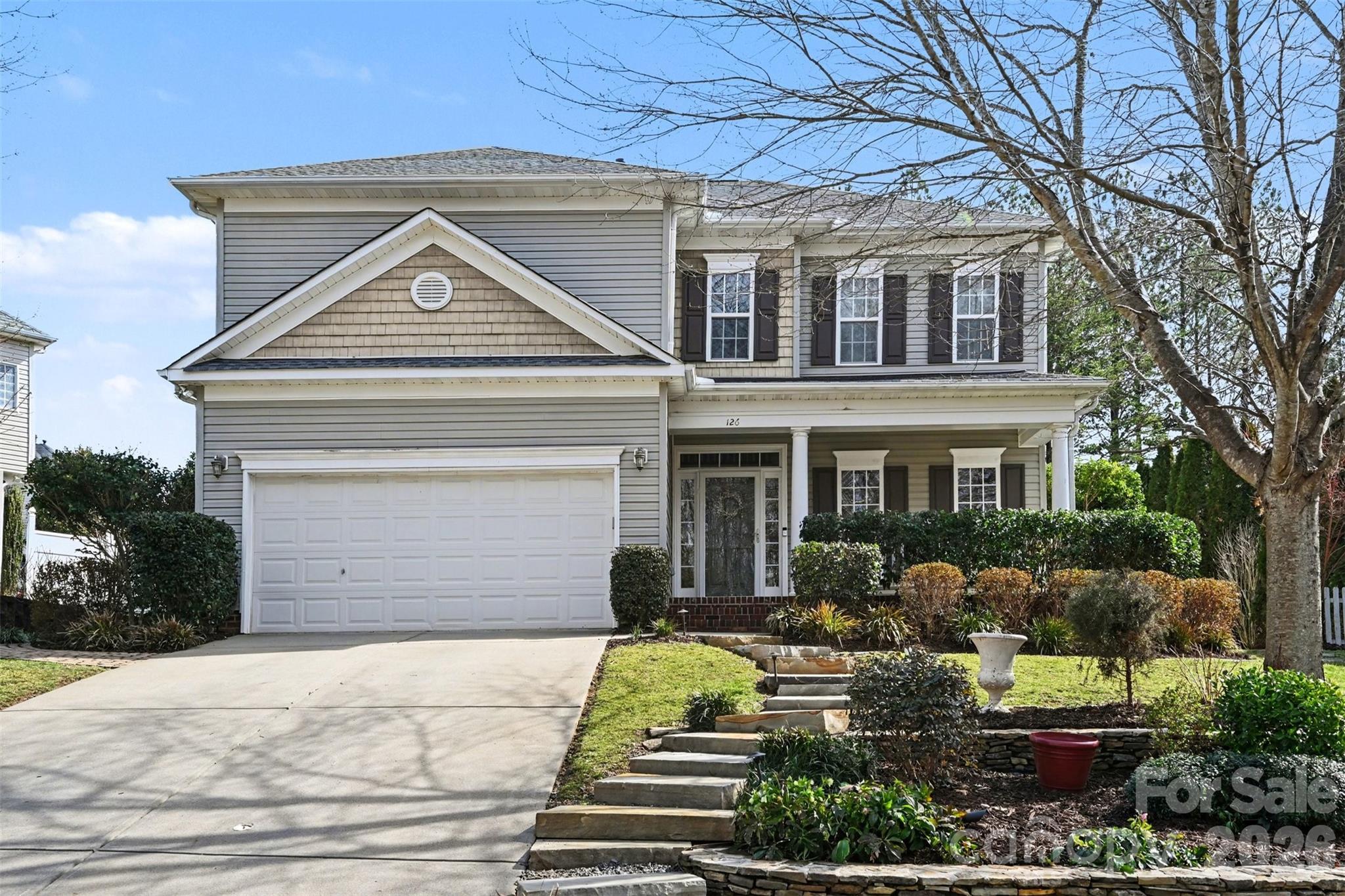 126 Burtons Barn Road Mooresville, NC 28115 - Photo 2 of 48 a front view of a house with garden