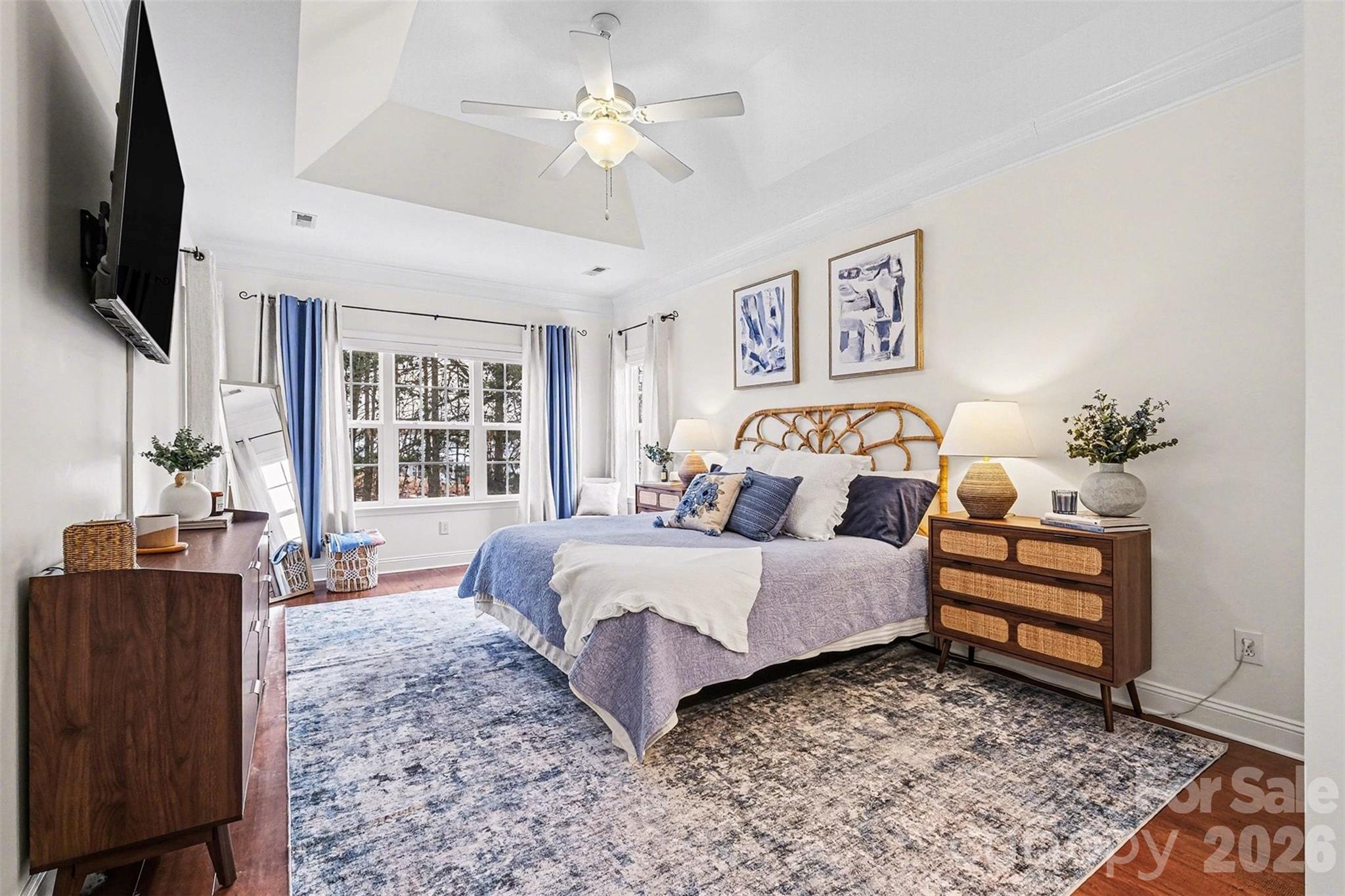 126 Burtons Barn Road Mooresville, NC 28115 - Photo 34 of 48 a spacious bedroom with a bed a couch and a flat screen tv