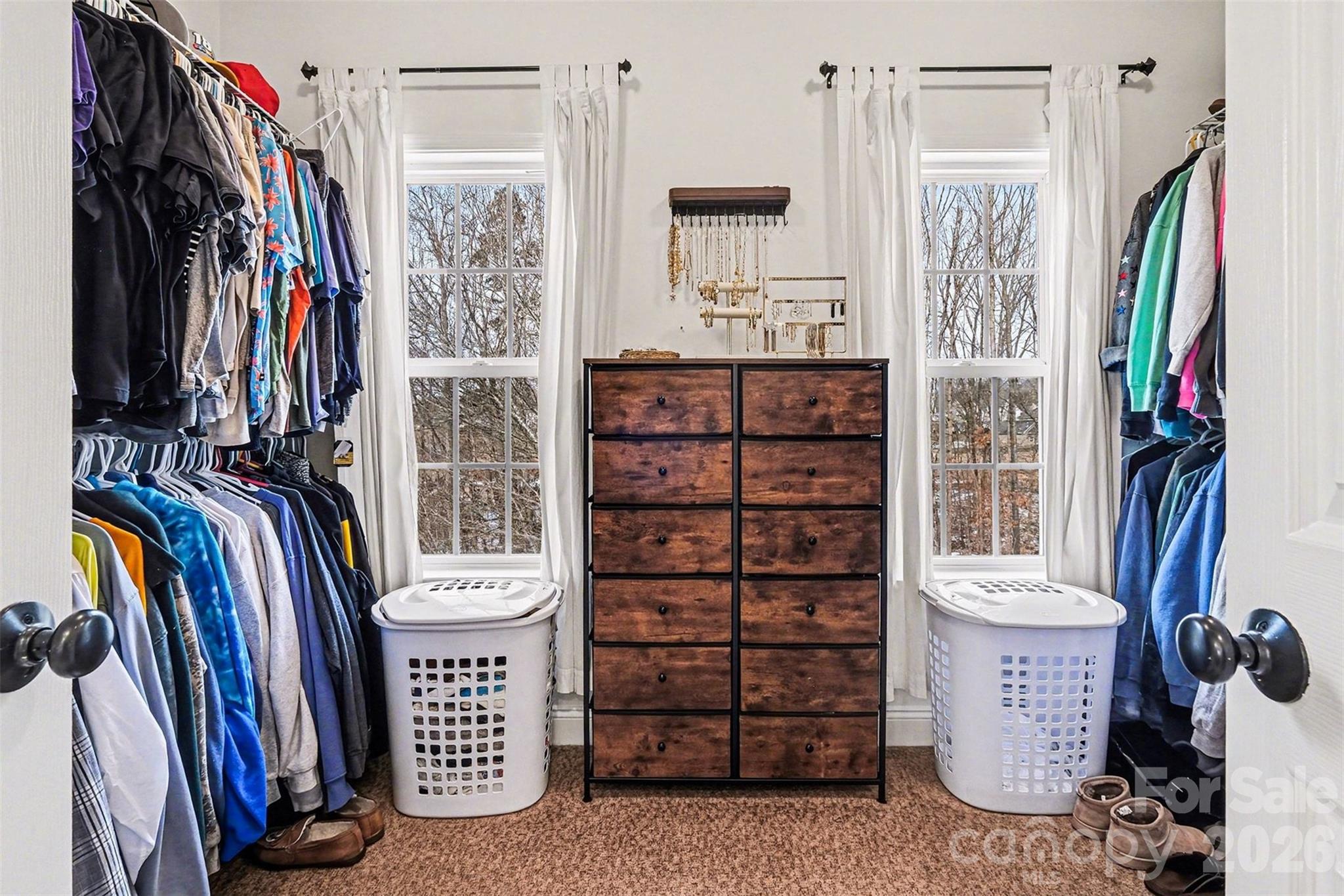 126 Burtons Barn Road Mooresville, NC 28115 - Photo 40 of 48 a view of walk in closet with clothes and shoes