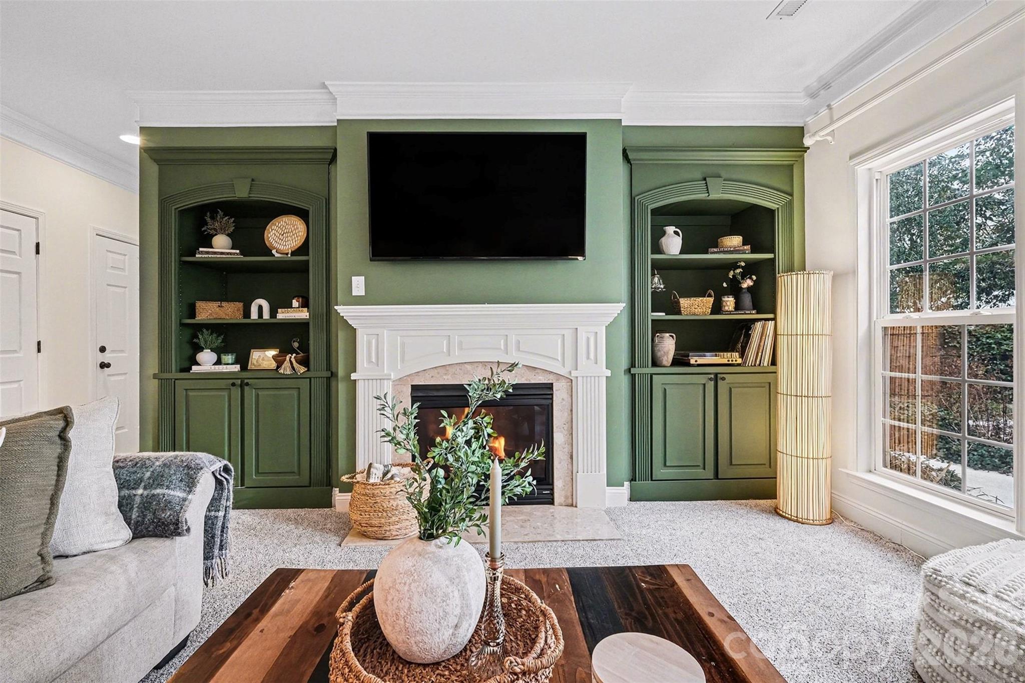 126 Burtons Barn Road Mooresville, NC 28115 - Photo 8 of 48 a living room with furniture a flat screen tv and a fireplace