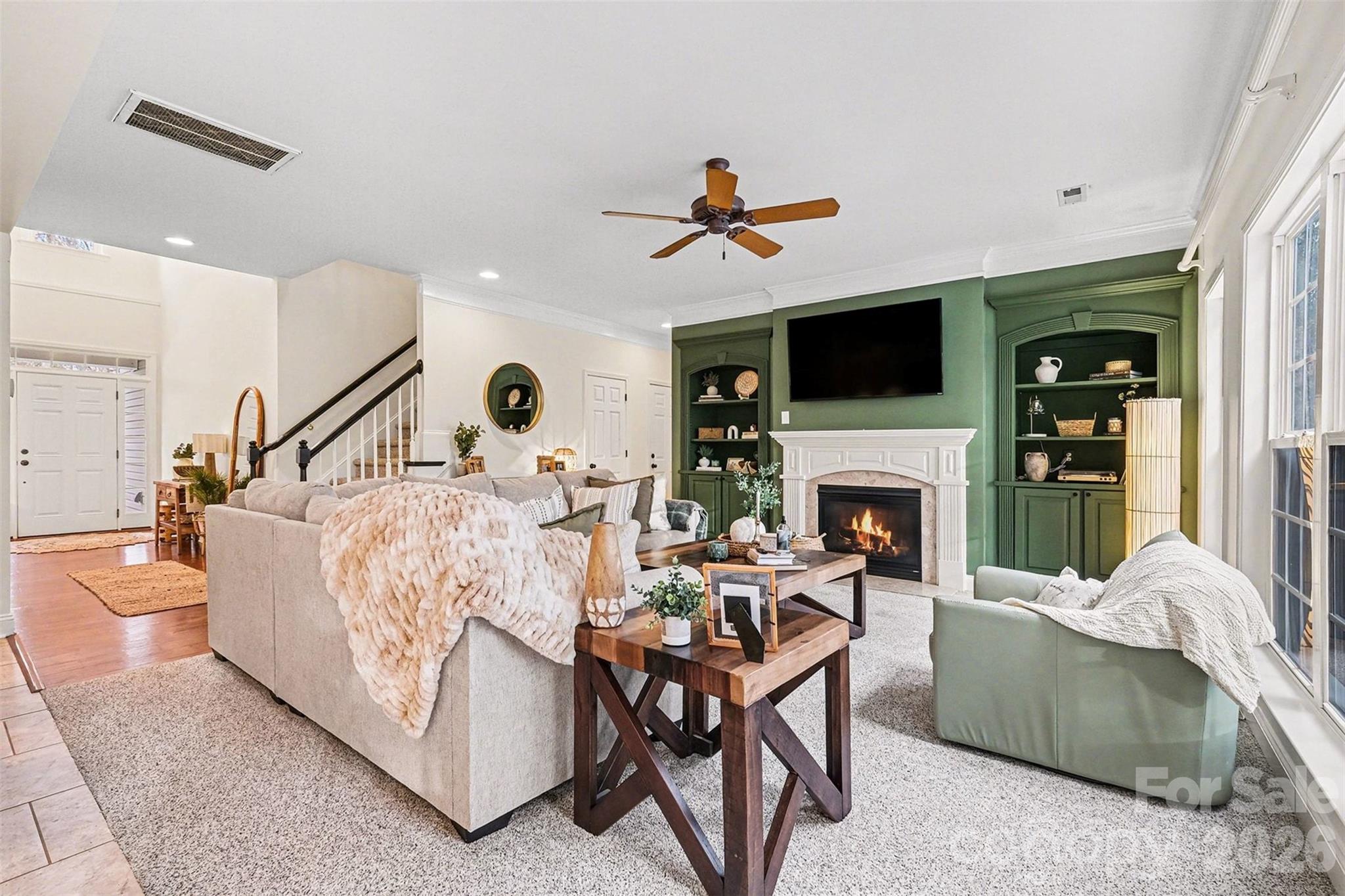 126 Burtons Barn Road Mooresville, NC 28115 - Photo 9 of 48 a living room with furniture a flat screen tv and a fireplace