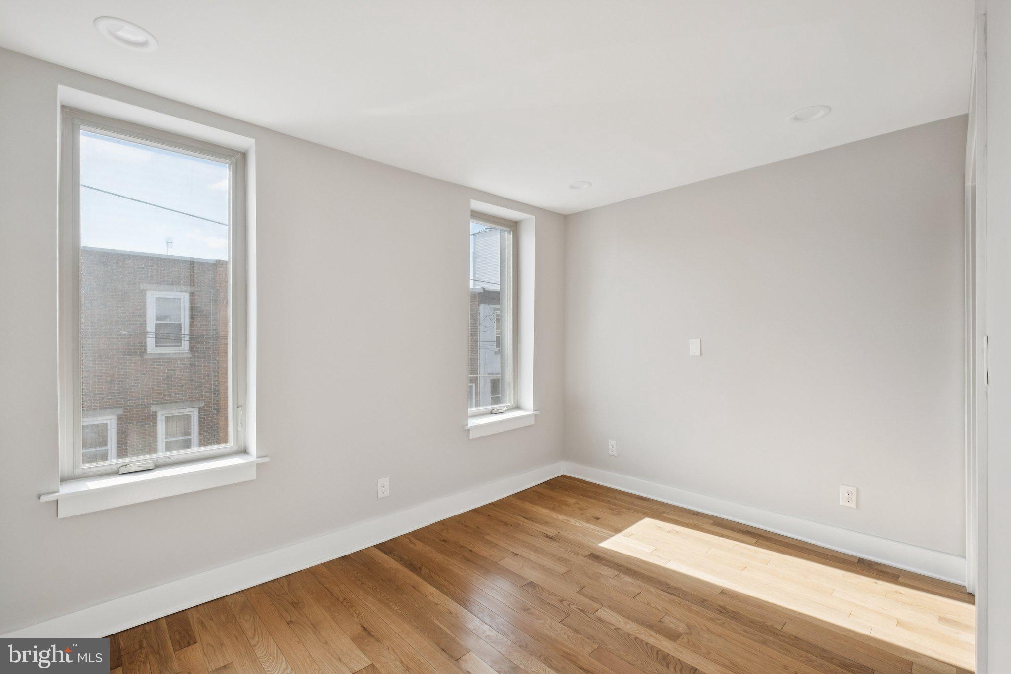 1811 Wilder Street Philadelphia, PA 19146 - Photo 22 of 37 a view of an empty room with wooden floor and a window