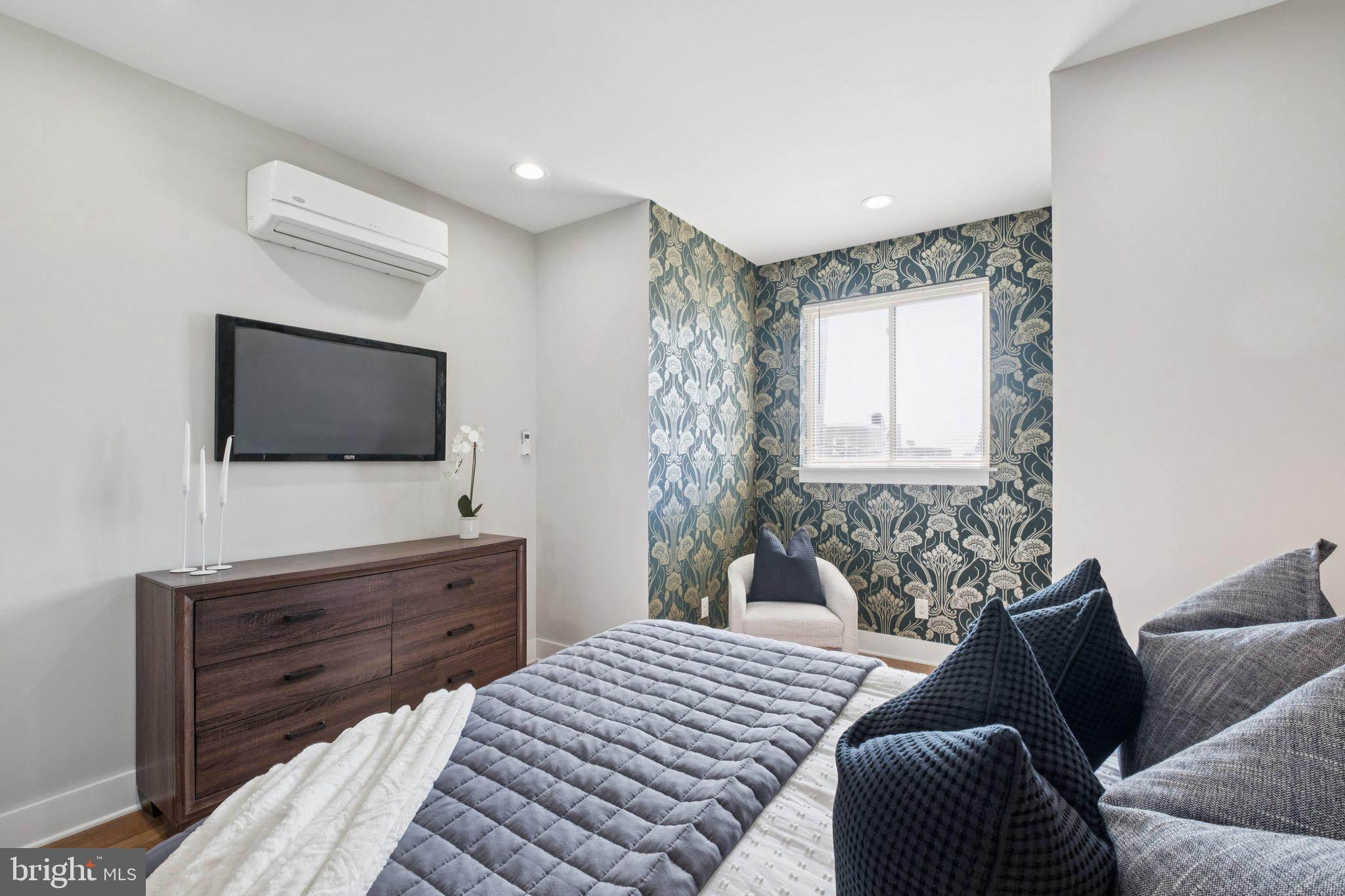 1811 Wilder Street Philadelphia, PA 19146 - Photo 26 of 37 a bedroom with a bed and a flat screen tv