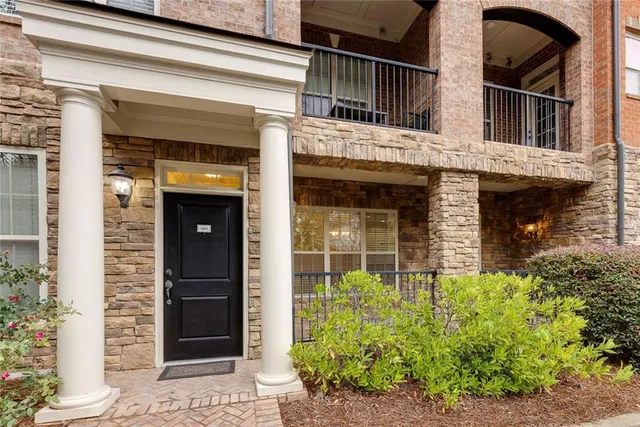 a view of a house with potted plants