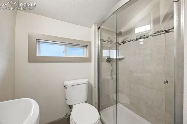 a bathroom with a toilet and shower