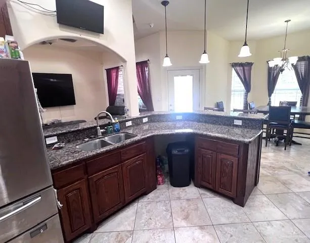 a spacious kitchen with a sink and a wooden floor
