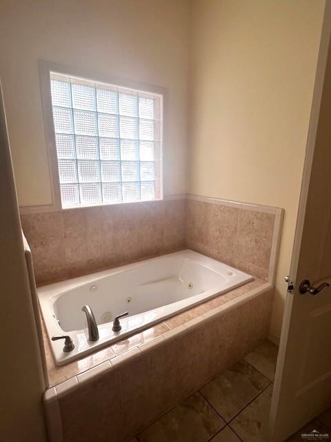 2102 Stone Gate Drive Harlingen, TX 78552 - Photo 18 of 35 a bathroom with a bathtub and a window