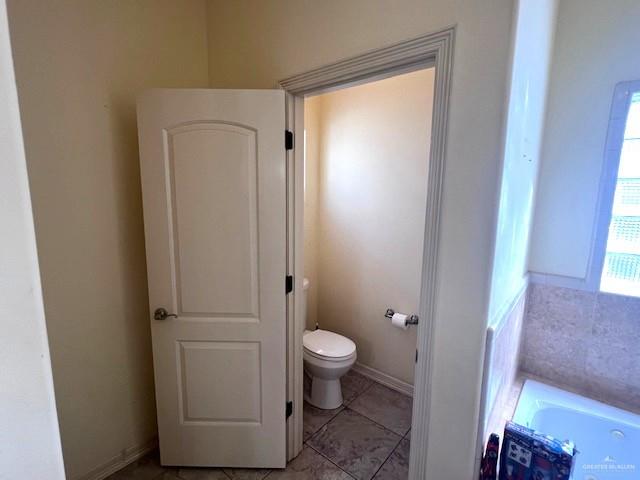 2102 Stone Gate Drive Harlingen, TX 78552 - Photo 19 of 35 a bathroom with a granite countertop toilet and a sink