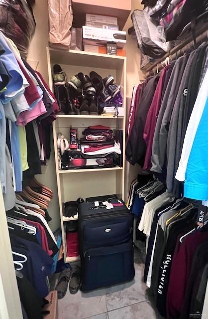 2102 Stone Gate Drive Harlingen, TX 78552 - Photo 21 of 35 a view of walk in closet with clothes and shoes