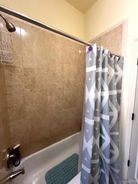 2102 Stone Gate Drive Harlingen, TX 78552 - Photo 26 of 35 a bathroom with a shower curtain and a shower
