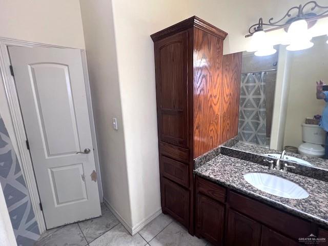 2102 Stone Gate Drive Harlingen, TX 78552 - Photo 27 of 35 a bathroom with a granite countertop sink and a mirror