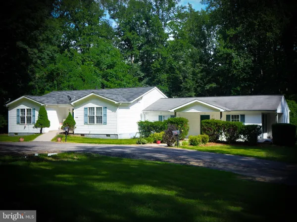 a front view of a house with a yard table and chairs