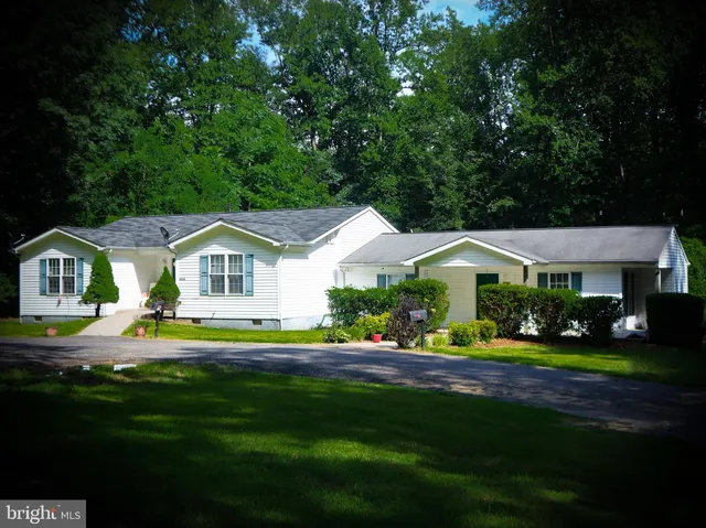 a front view of a house with a yard table and chairs