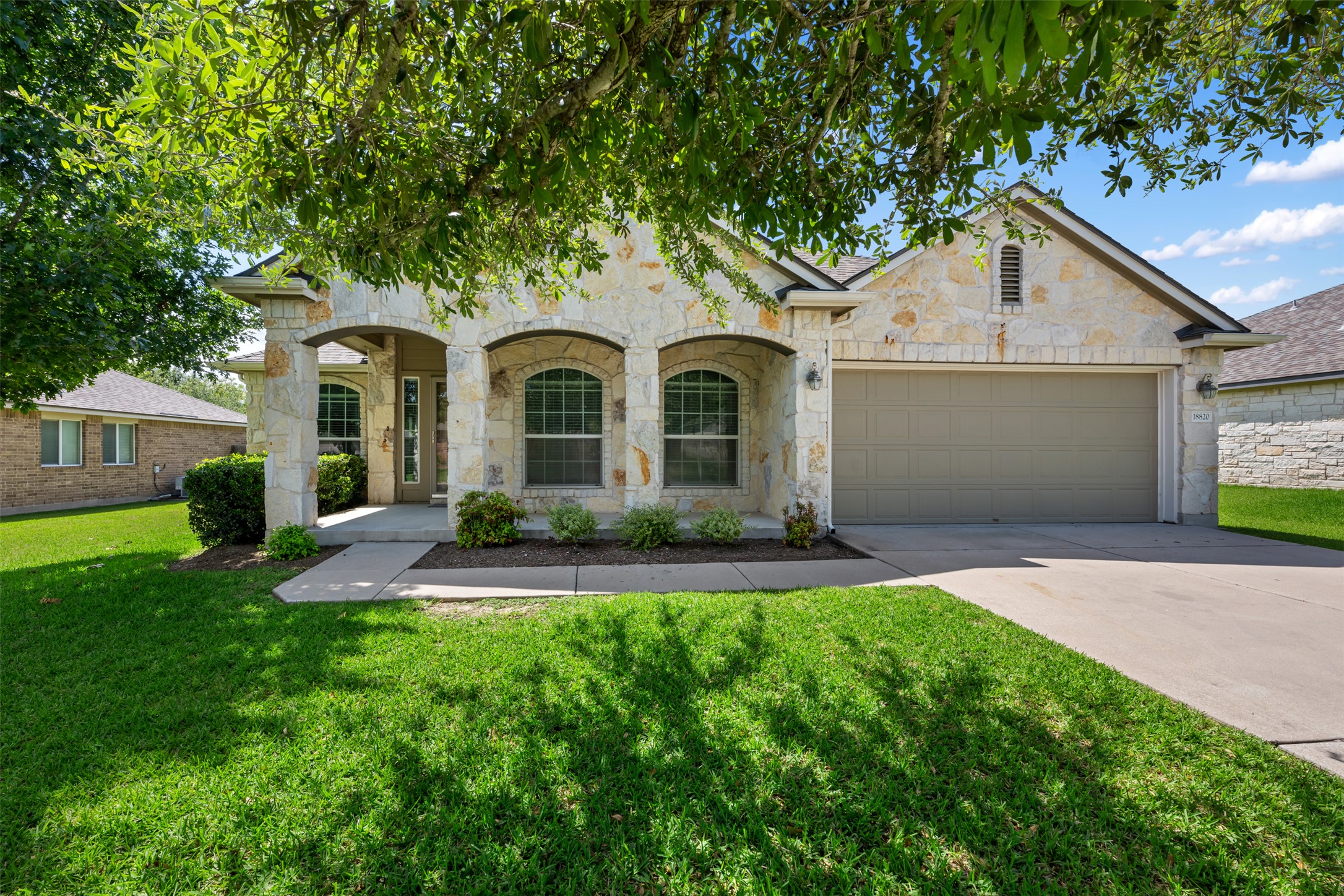 18820 Edinburgh Castle Road Pflugerville, TX 78660 - Photo 2 of 37 a front view of a house with a yard and garage