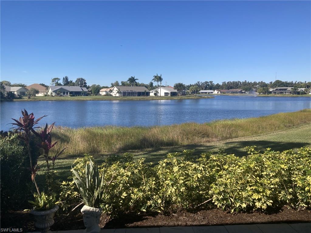 3685 Stone Way Estero, FL 33928 - Photo 12 of 27 a view of a lake with a house in the background